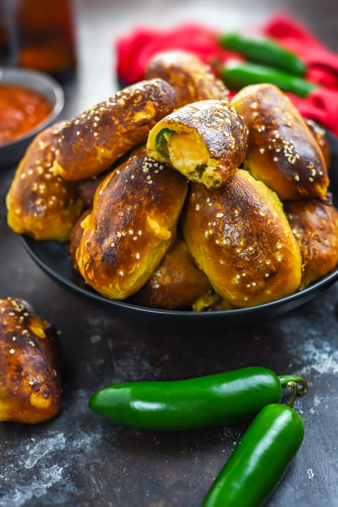 Jalapeño Popper Pretzel Bites. These cheesy, spicy party appetizers are so easy to make thanks to a premade dough shortcut! A video in the post shows exactly how it's done. | hostthetoast.com