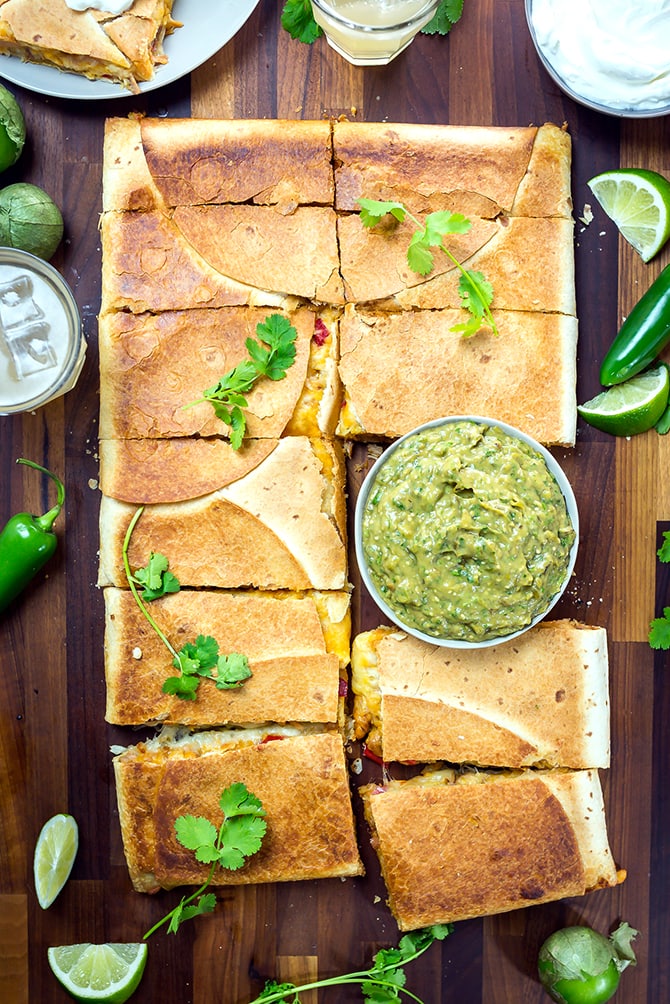 Chipotle Chicken Sheet Pan Quesadilla with Avocado Salsa Verde. This is how you make Mexican appetizers for a crowd. Cheesy, meaty, smoky, and oh-so-cheesy. | hostthetoast.com