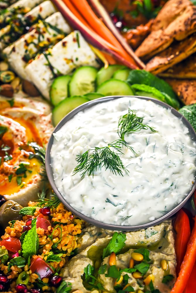 Mezze Party Platter. Loaded up with hummus, baba ganoush, marinated feta, tzatziki, tomato rice salad, muhammara, za'atar pita chips, sliced veggies, and nuts, this platter is the perfect spread of Mediterranean and Middle Eastern flavors. | hostthetoast.com