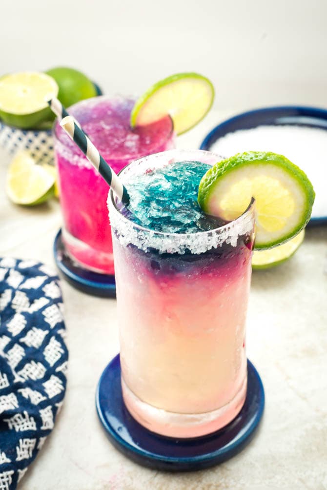 Color-Changing Slushy Margaritas. This recipe uses a secret ingredient to create color-changing blue ice. It's also perfectly slushy with no blender required! | hostthetoast.com