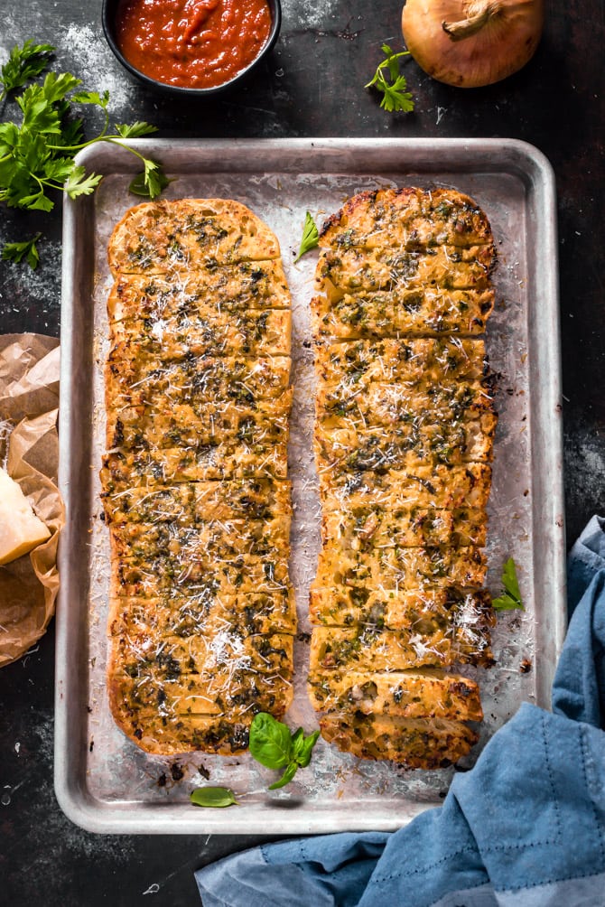 Caramelized Onion and Garlic Bread. A sweet garlic-onion-herb butter is smeared over spongy ciabatta, hit with plenty of parmesan, and baked until beautifully browned. | hostthetoast.com