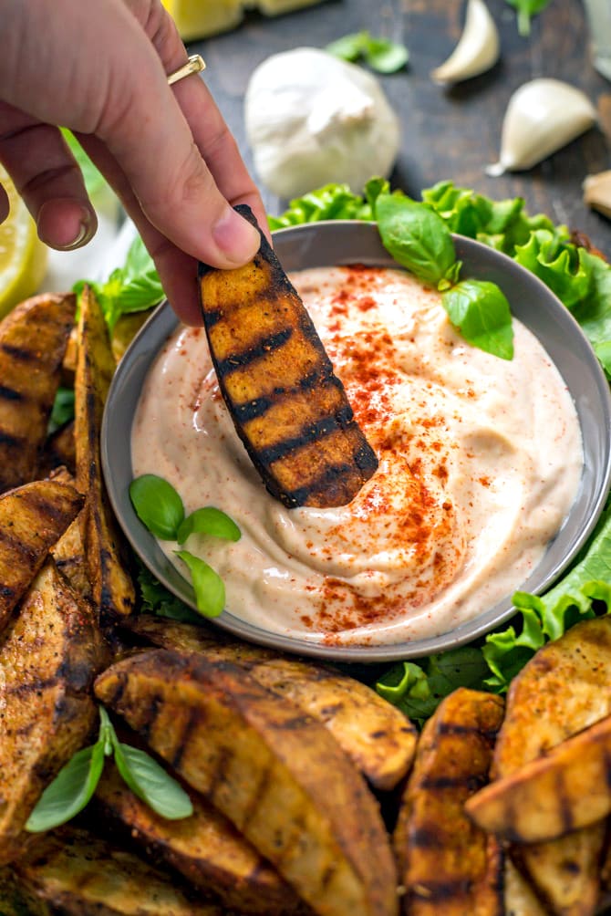 Grilled Potato Wedge Fries with Roasted Garlic Aioli. No burger is complete without a side of fries, so whip these easy grilled, seasoned wedges up for your next barbecue. The aioli, made from grill-roasted garlic, is just as addictive as the fries! | hostthetoast.com