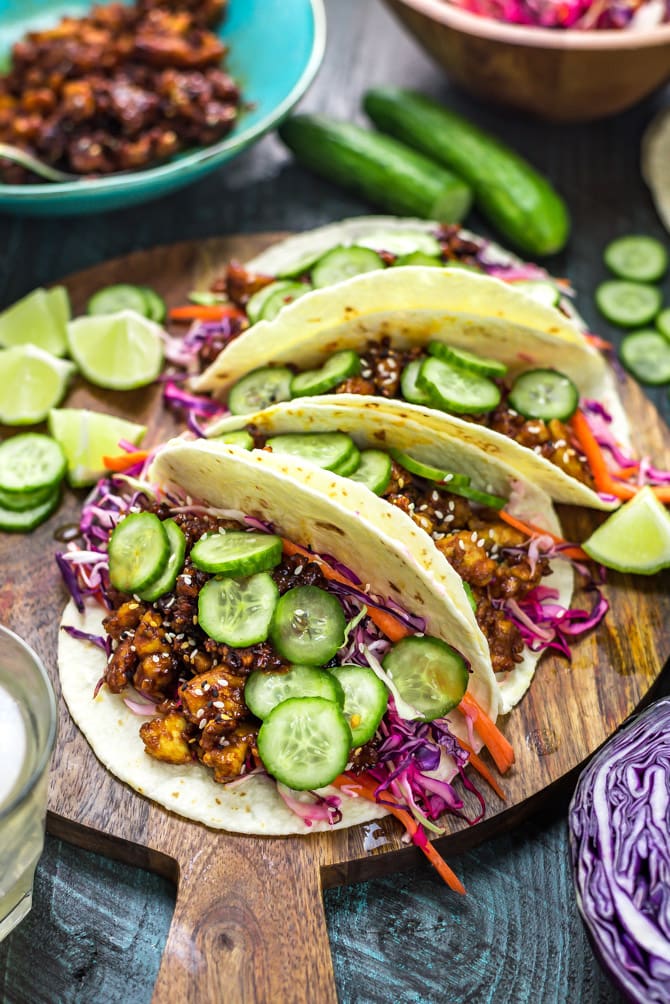 Korean-Inspired Crispy Tofu Tacos on a wooden cutting board.