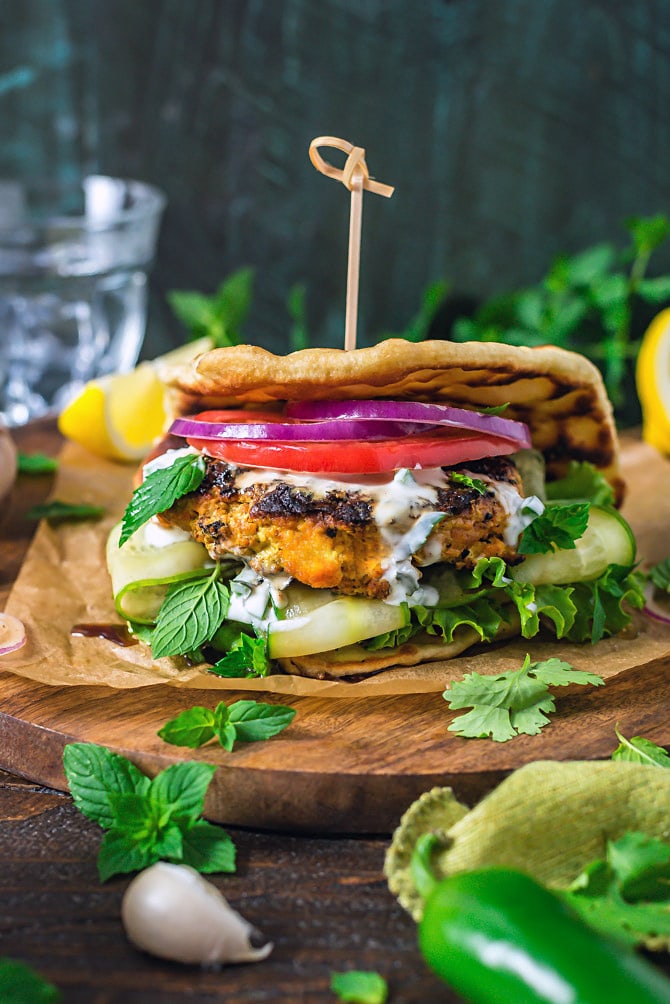 Grilled Tandoori Chicken Patties served as a sandwich with naan bread and Jalapeno-Mint Yogurt Sauce.