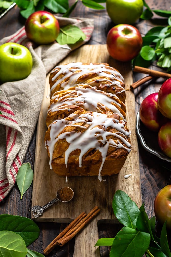 Glazed Apple Fritter Pull-Apart Bread sitting on top of a wooden serving board.