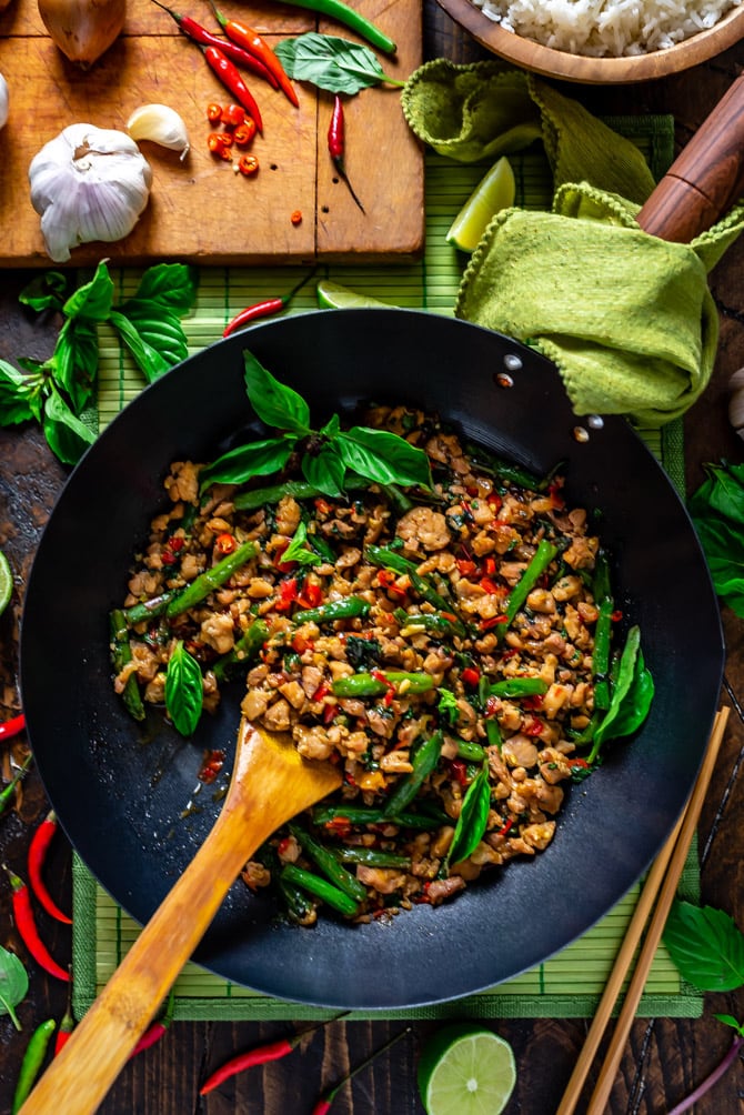 15 Minute Thai Basil Chicken in a large wok with a wooden spoon.