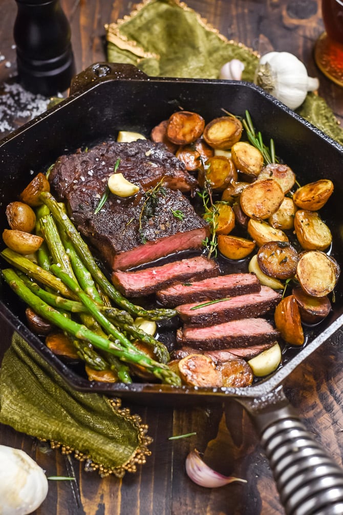 Pan-Fried Garlic Butter Steak with Crispy Potatoes and Asparagus. Meet the equally simple and sexy date night meal that will change the way you tackle romantic dinners forever. The key? A high heat sear on the steak and lots of basting with garlicky herb butter to finish off the cooking process. | hostthetoast.com