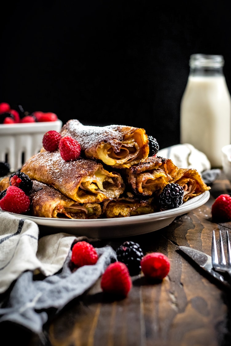 The classic sweet and savory sandwich gets transformed into the perfect rolled-up breakfast in the form of these Monte Cristo Crepes. Stuffed with ham, cheese, and a raspberry-dijon mixture, then dipped in egg and pan-fried in butter, they're as full of flavor as they are impressive when served for a brunch get-together. | hostthetoast.com