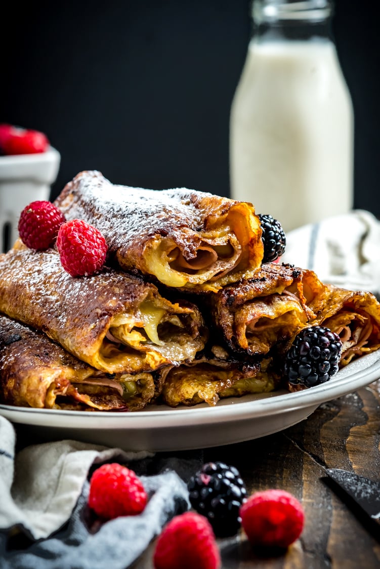 The classic sweet and savory sandwich gets transformed into the perfect rolled-up breakfast in the form of these Monte Cristo Crepes. Stuffed with ham, cheese, and a raspberry-dijon mixture, then dipped in egg and pan-fried in butter, they're as full of flavor as they are impressive when served for a brunch get-together. | hostthetoast.com
