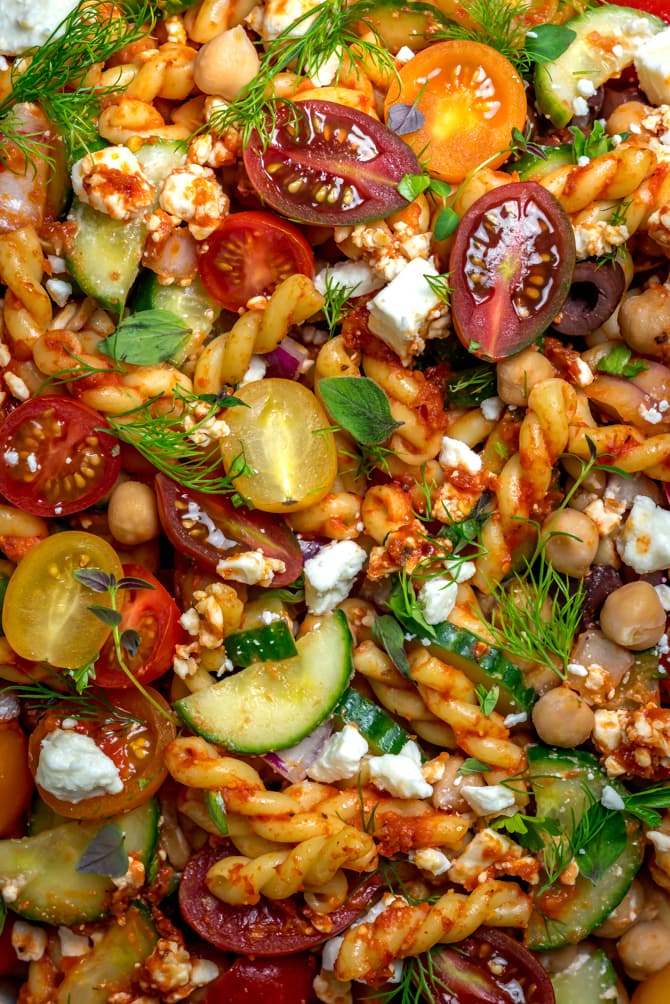 This super easy-to-make summer side dish beats store-bought pasta salad any day. Loaded up with Mediterranean flavors, Greek Pasta Salad with Sun Dried Tomato Vinaigrette is bright, zesty, and delightfully briney. | hostthetoast.com