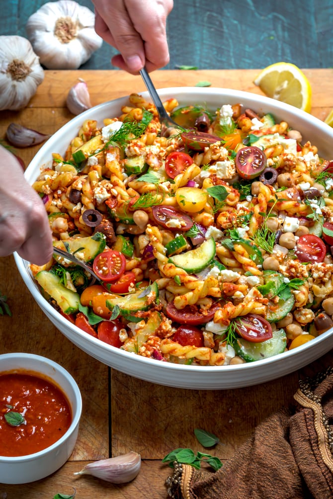 This super easy-to-make summer side dish beats store-bought pasta salad any day. Loaded up with Mediterranean flavors, Greek Pasta Salad with Sun Dried Tomato Vinaigrette is bright, zesty, and delightfully briney. | hostthetoast.com