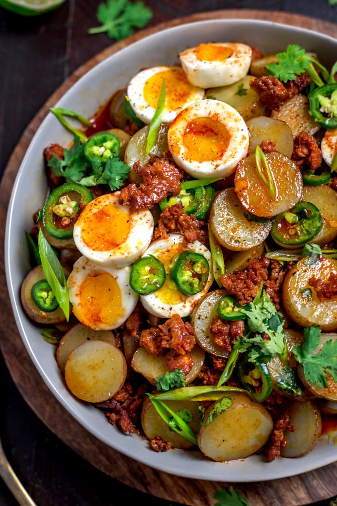 With a whisper of smoke and spice, Warm Chorizo Potato Salad is a Mexican-inspired spin on the German classic. Served with soft-boiled eggs and a chorizo vinaigrette, this mayo-free mash-up is best served warm.  | hostthetoast.com