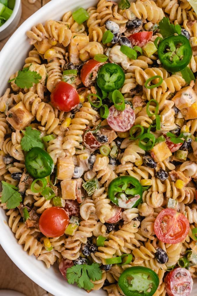 This zesty Southwestern Pasta Salad features all the best and boldest fixings. Bacon, jalapeños,  black beans, corn, and more are dressed in a creamy chipotle ranch dressing that will have your whole party lining up for second helpings.