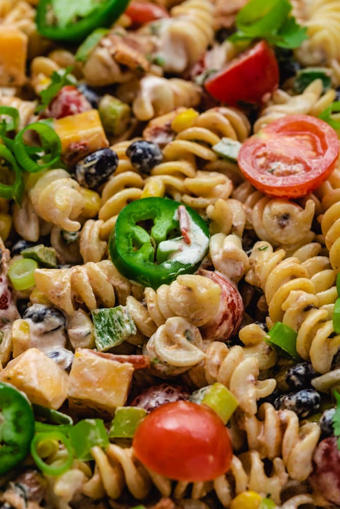 This zesty Southwestern Pasta Salad features all the best and boldest fixings. Bacon, jalapeños,  black beans, corn, and more are dressed in a creamy chipotle ranch dressing that will have your whole party lining up for second helpings.