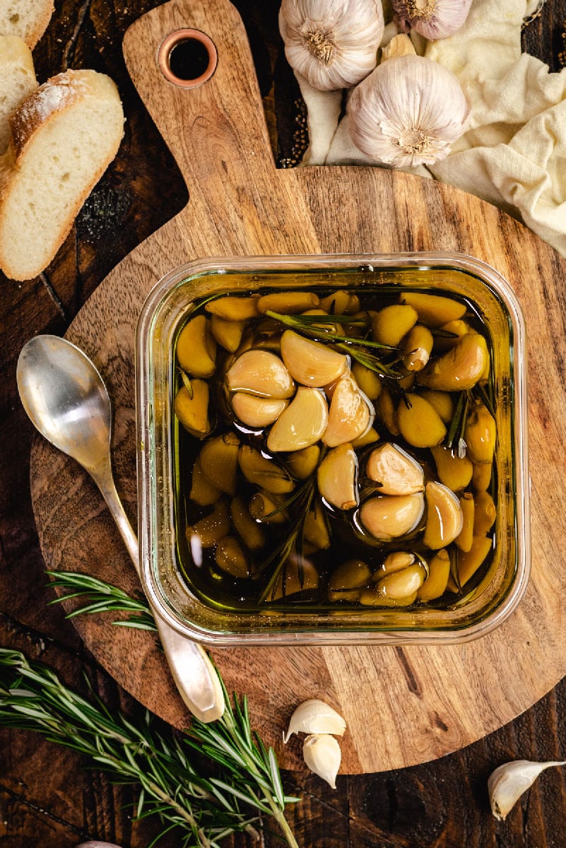 Garlic lovers rejoice: You can make homemade garlic confit and garlic oil with only a few minutes of prep time. Slowly roasting garlic cloves in olive oil allows them to become mild, caramelized, and tender enough to spread with a butter knife.