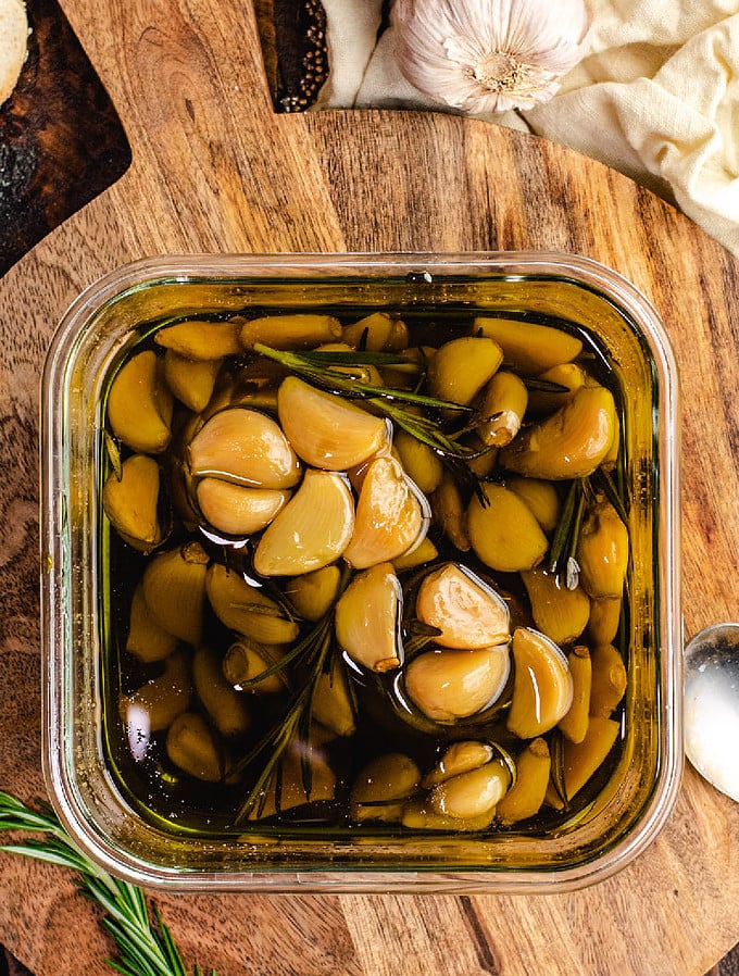 Garlic lovers rejoice: You can make homemade garlic confit and garlic oil with only a few minutes of prep time. Slowly roasting garlic cloves in olive oil allows them to become mild, caramelized, and tender enough to spread with a butter knife.