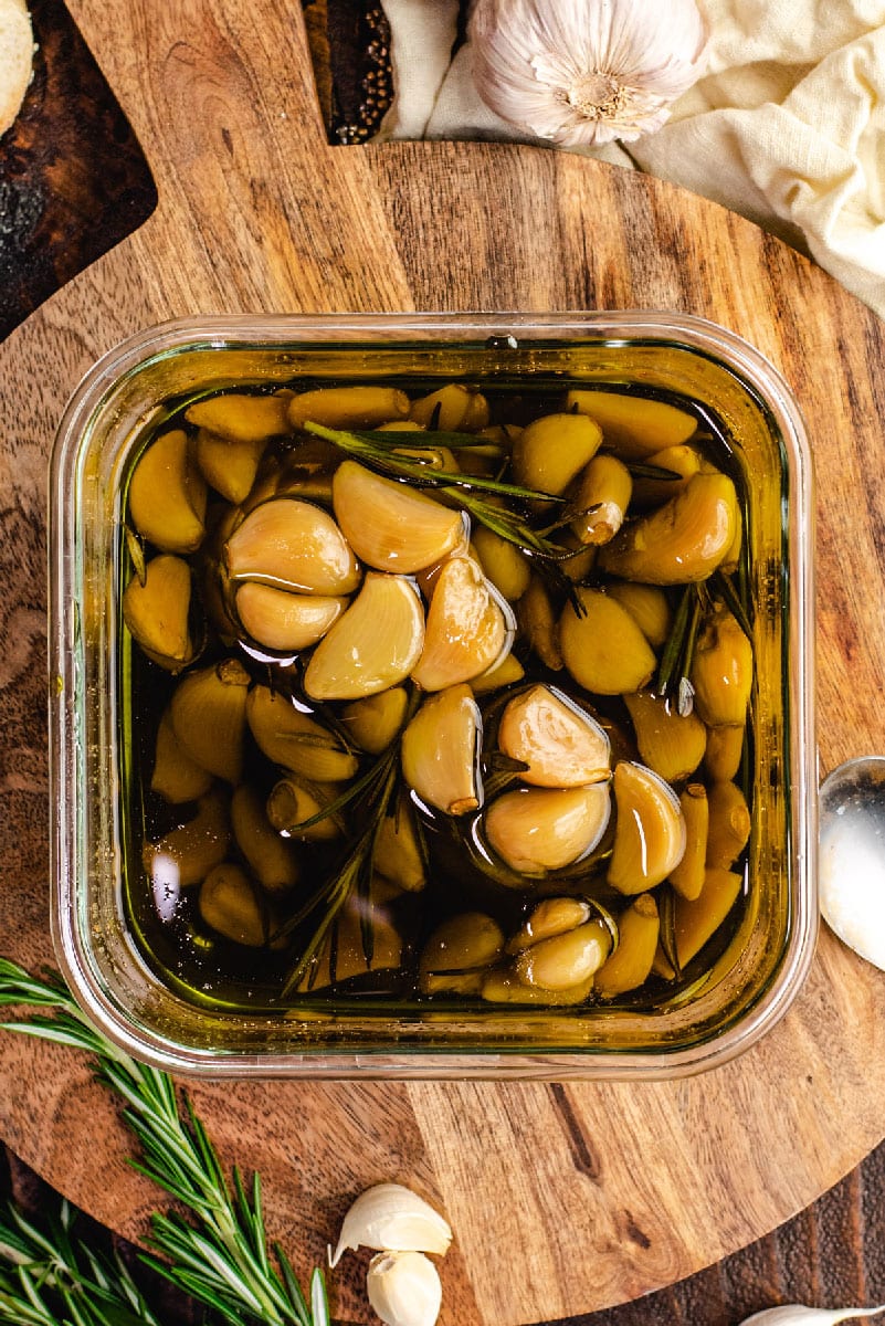 Garlic lovers rejoice: You can make homemade garlic confit and garlic oil with only a few minutes of prep time. Slowly roasting garlic cloves in olive oil allows them to become mild, caramelized, and tender enough to spread with a butter knife.