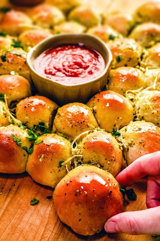 What do you get when you combine garlic knots, melty mozzarella, and mini Italian meatballs? You get the perfect party appetizer: Cheesy Garlic Meatball Bombs. It's like a garlic-butter-slathered meatball sub, but snack-sized, and minus the mess. 