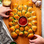 What do you get when you combine garlic knots, melty mozzarella, and mini Italian meatballs? You get the perfect party appetizer: Cheesy Garlic Meatball Bombs. It's like a garlic-butter-slathered meatball sub, but snack-sized, and minus the mess. 