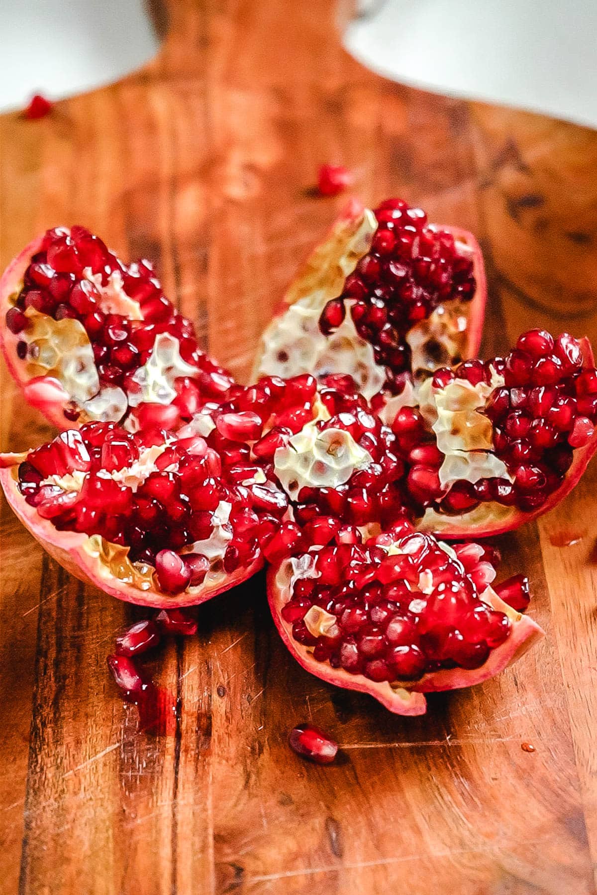An open pomegranate with segments intact and the seeds exposed