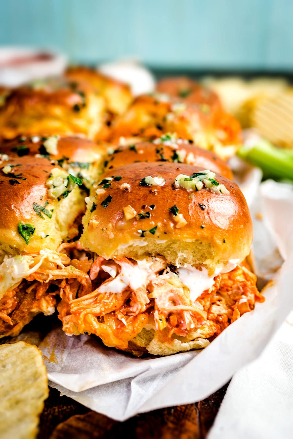 These Buffalo Chicken Sliders are loaded up with spicy buffalo sauce-tossed chicken, gooey melted cheese, and creamy ranch slaw, all nestled between garlic-butter brushed brioche buns. 