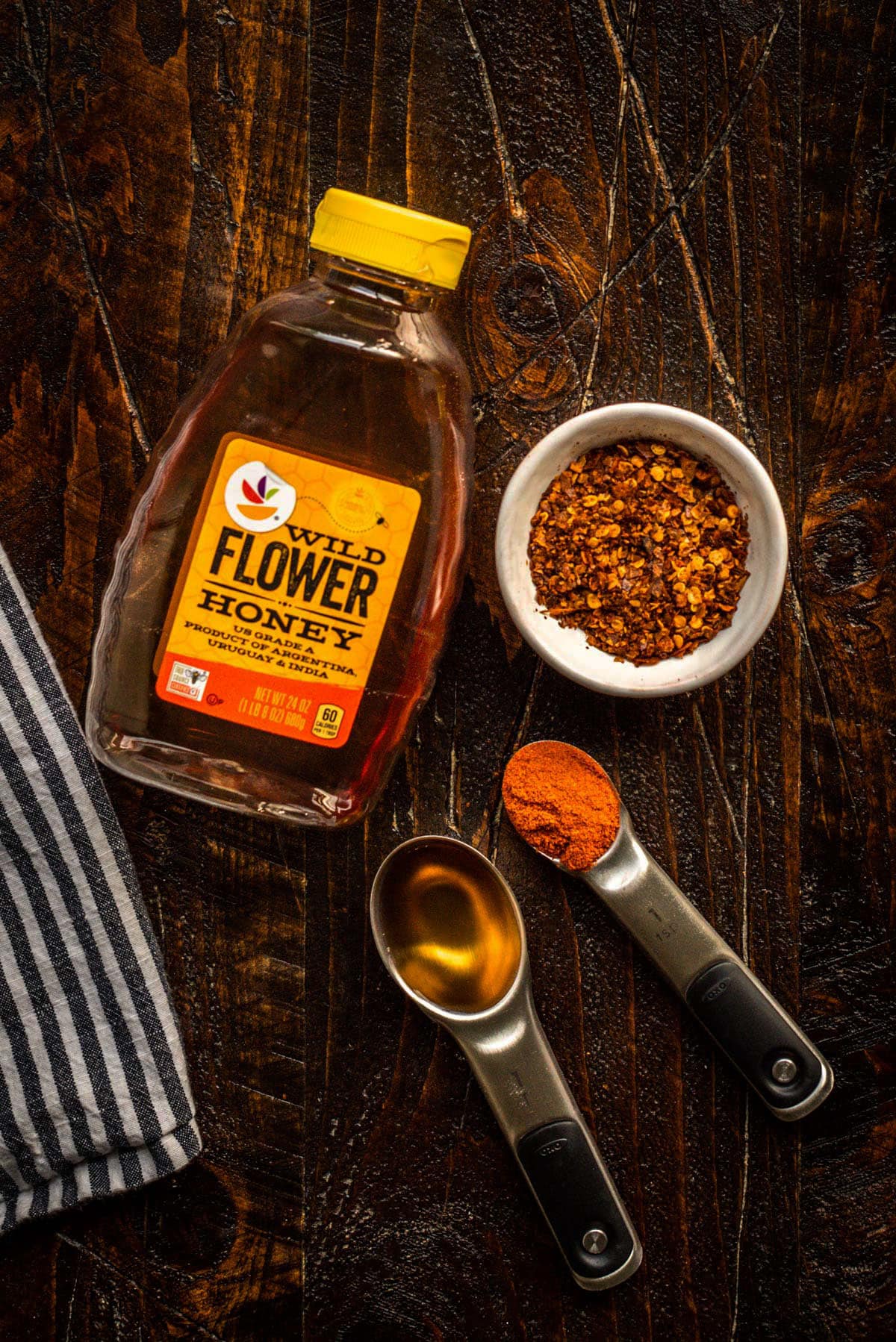 Hot Honey Ingredients: Wild Flower Honey, chili flakes, cayenne powder, and apple cider vinegar. 