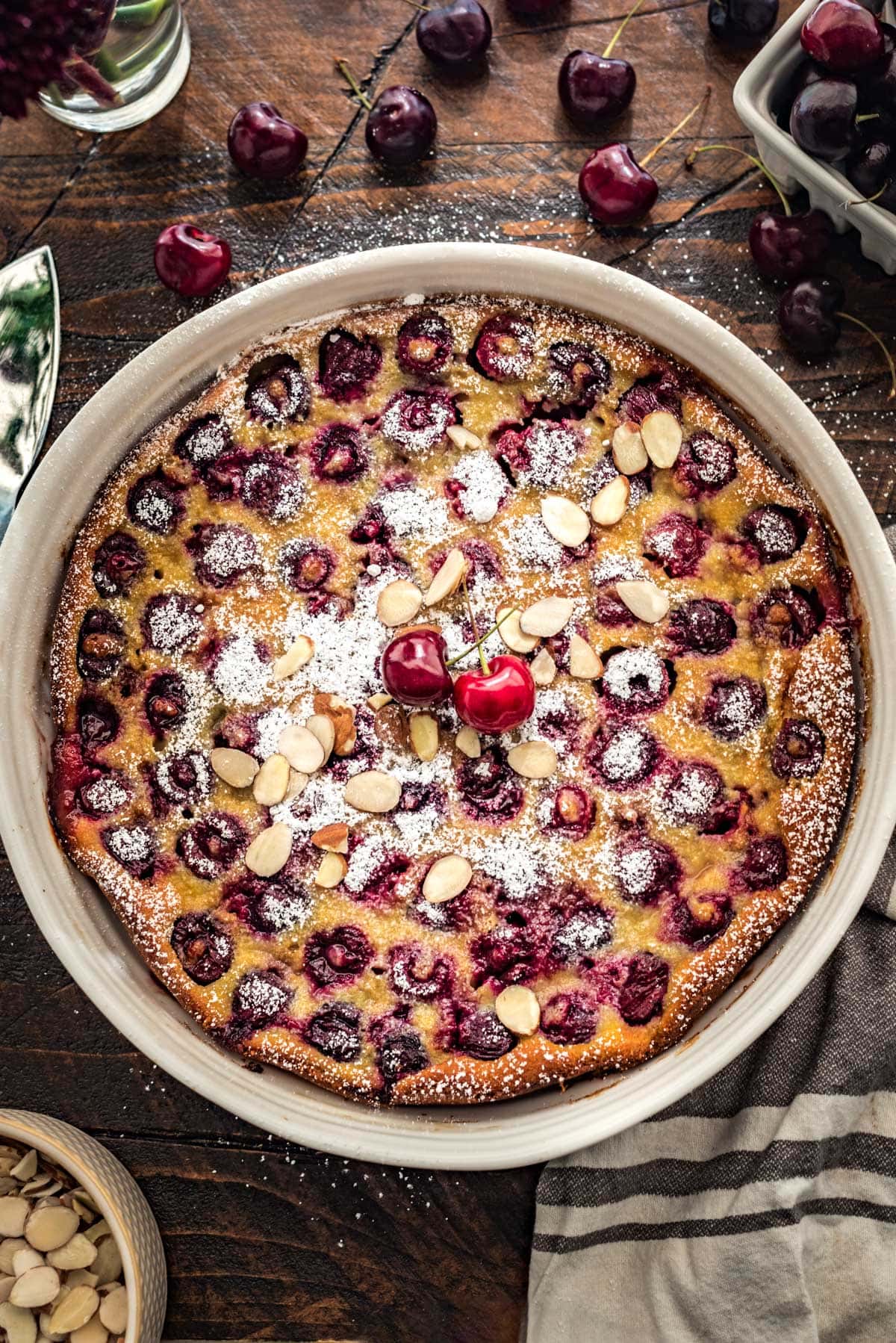 A cherry clafoutis baked in a large white dish.